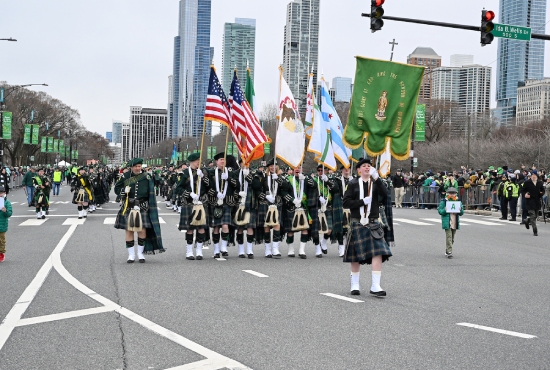A pipe band marching through downtown Chicago in the St. Patrick’s Day Parade